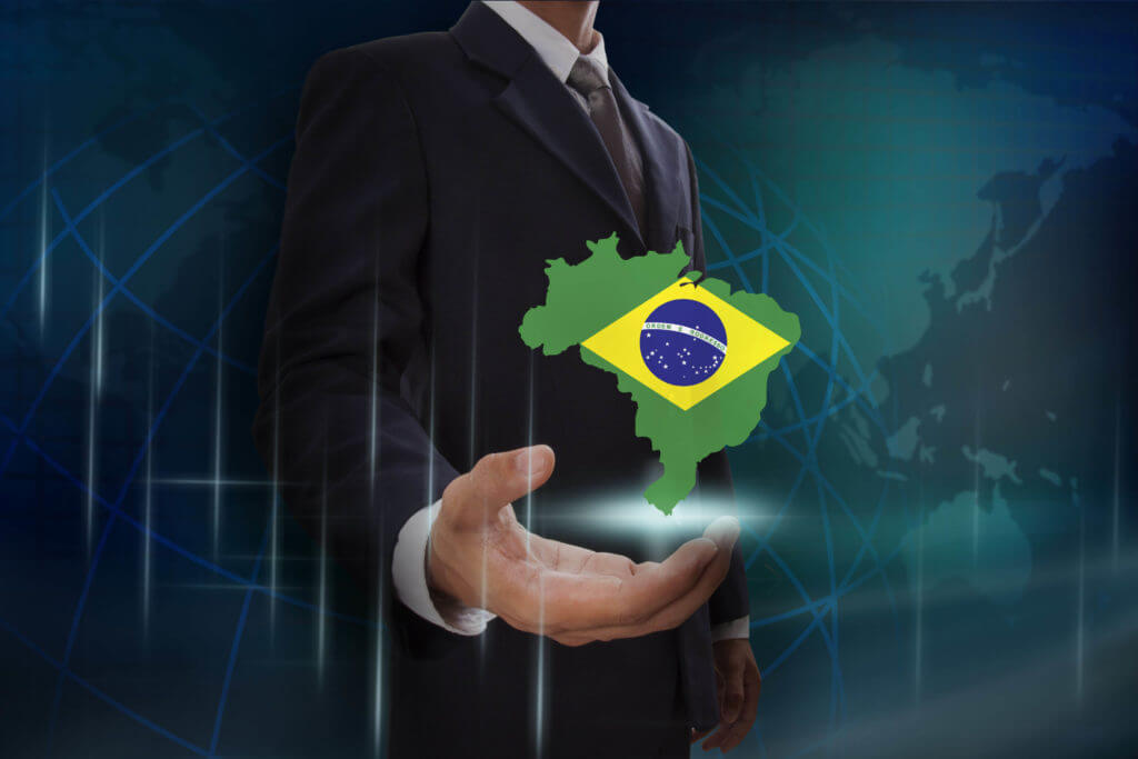 Карта с флагом Бразилии в руке